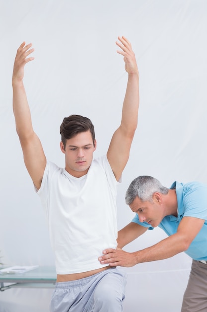 Doctor examining his patient back 