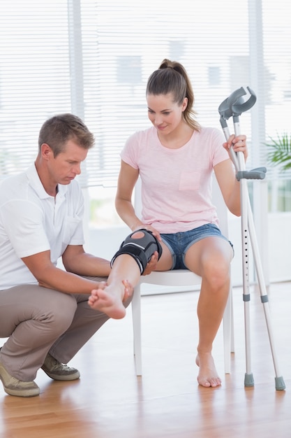 Doctor examining his patient knee