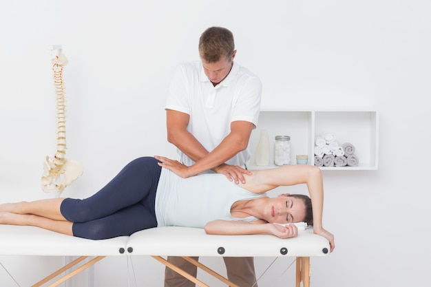 Doctor examining his patient pelvis