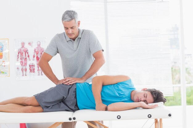 Doctor examining his patient pelvis