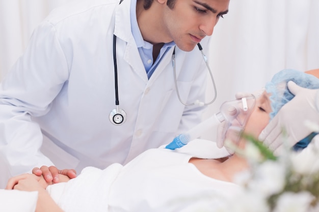 Doctor examining intensive care patient