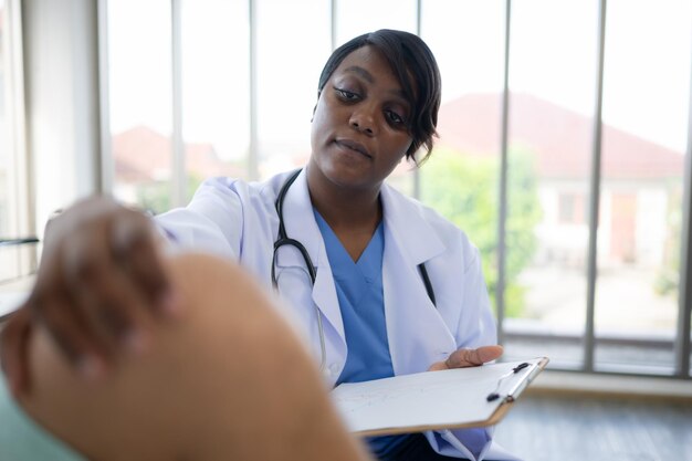 Doctor examining knee joint function of patient in hospital Medical health care