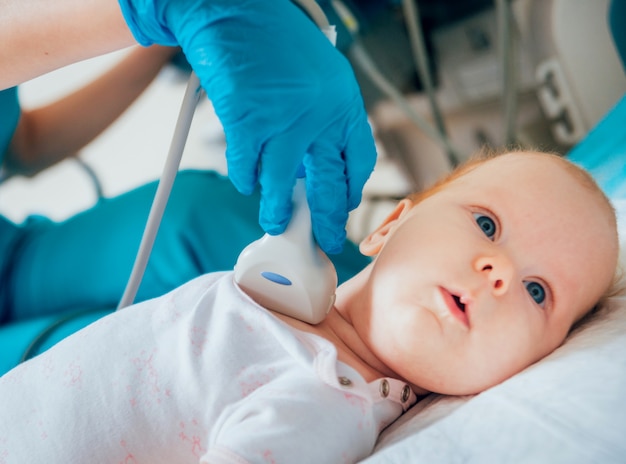 Doctor examining little boy