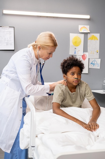 Doctor examining the little patient at hospital