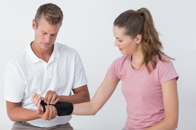 Doctor examining a man wrist