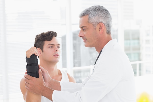 Doctor examining a man wrist