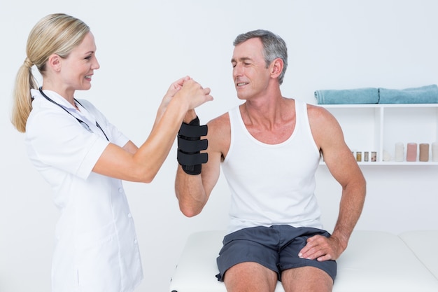 Doctor examining a man wrist