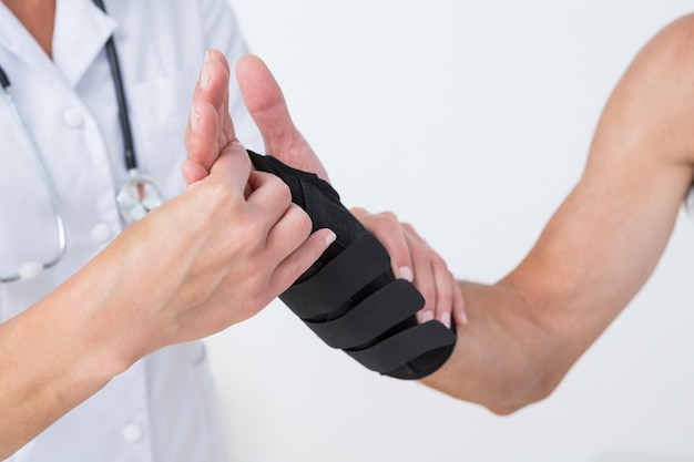 Doctor examining a man wrist