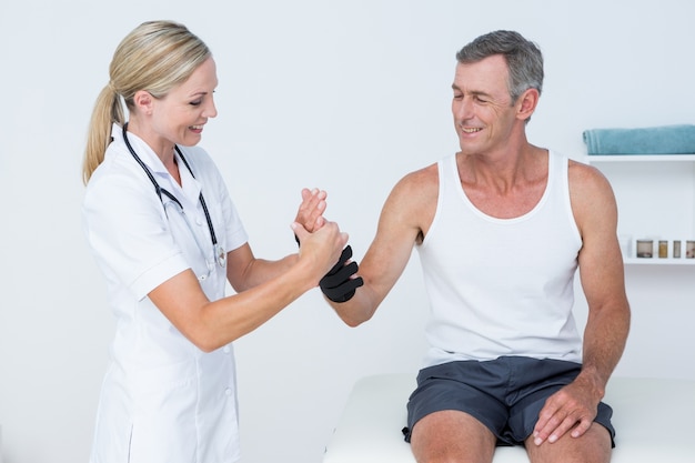 Doctor examining a man wrist