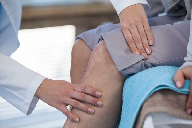 Doctor examining patient knee