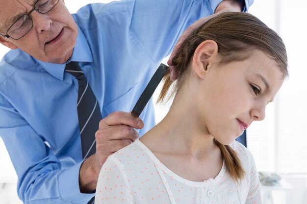 Doctor examining patient neck