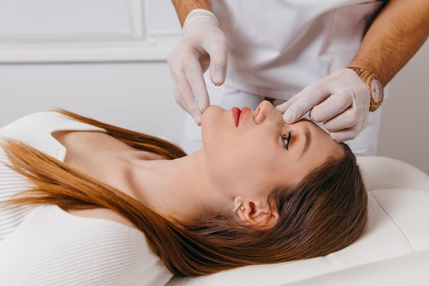 Doctor examining patient nose after rhinoplasty surgery medical
operation