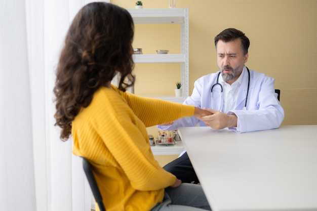 Doctor examining the patients arm and upper arm in doctors room Medical and healthcare concept