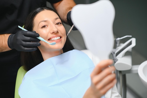 Photo doctor examining patients teeth closeup cosmetic dentistry