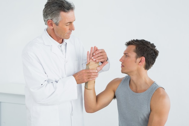 Doctor examining a young patients hand