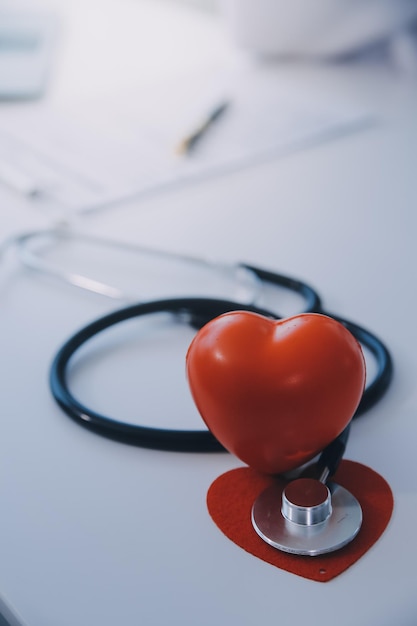 Doctor explaining heart to elderly patient Doctor explaining the heart model Doctors pen point to a model of the heart