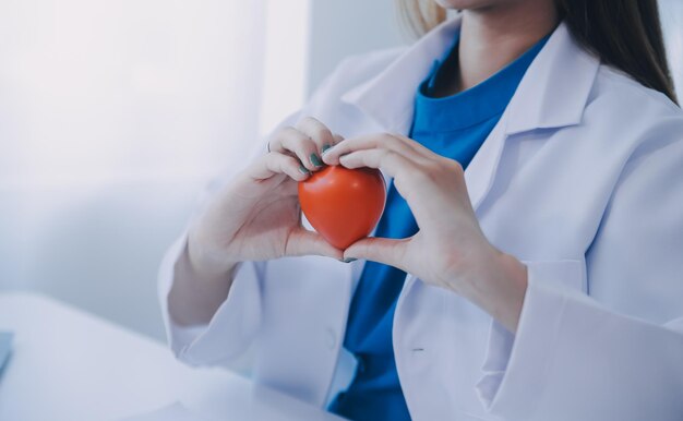 Doctor explaining heart to elderly patient Doctor explaining the heart model Doctors pen point to a model of the heart