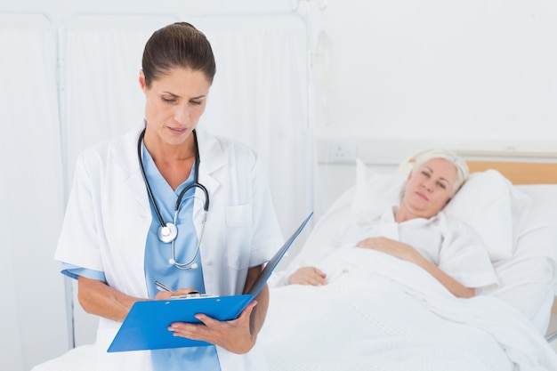 Doctor explaining report to female patient