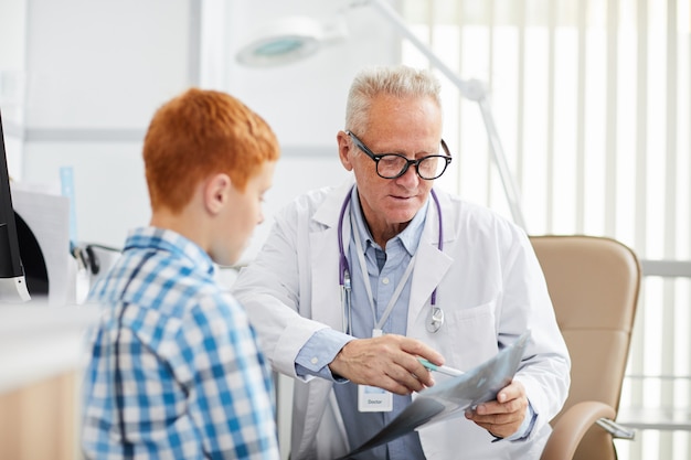 Doctor Explaining X-Ray to Child