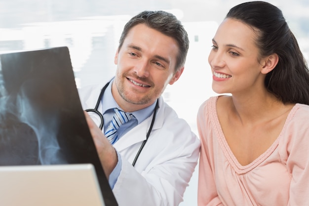 Doctor explaining x-ray report to a smiling patient