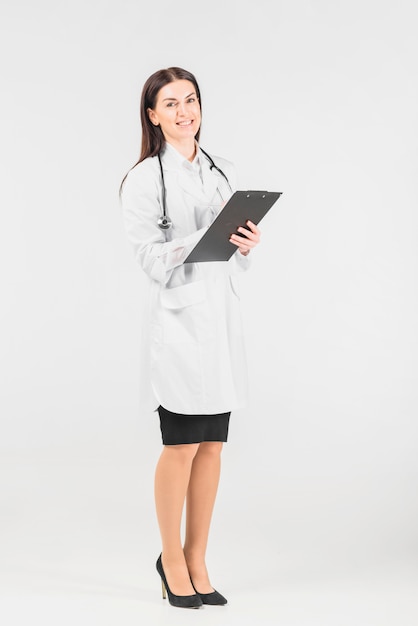 Doctor female smiling and holding clipboard 