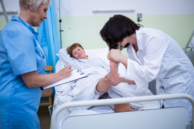 Doctor giving foot treatment to patient