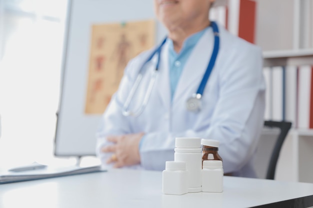 Doctor giving hope Close up shot of young female physician leaning forward to smiling elderly lady patient holding her hand in palms Woman caretaker in white coat supporting encouraging old person