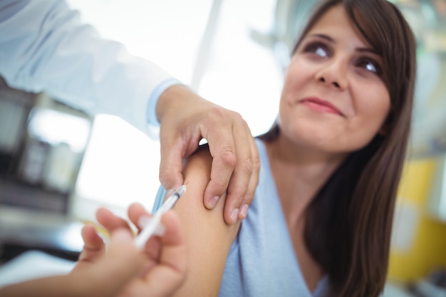 Doctor giving an injection to the patient