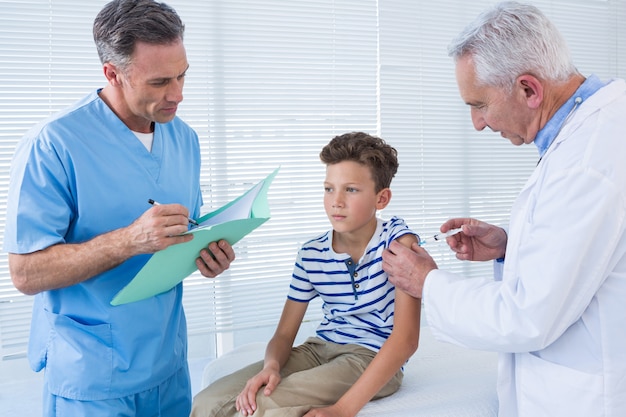 Doctor giving an injection to the patient