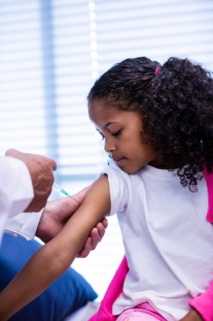 Doctor giving an injection to the patient