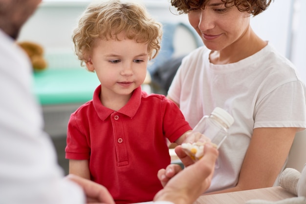 Doctor Giving Vitamins to Little Boy