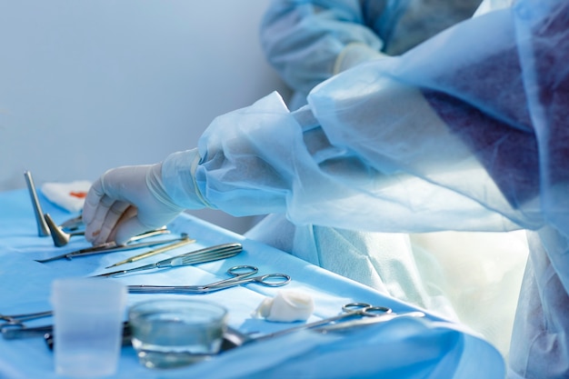 Photo a doctor in gloves holds a medical instrument during rhinoplasty, nose reconstruction