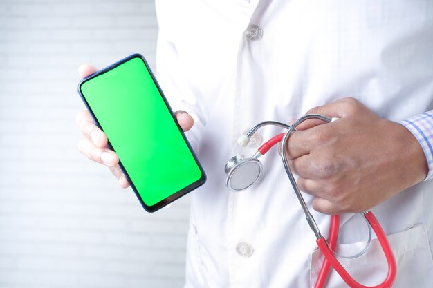 Doctor hand in latex gloves holding smart phone with empty screen