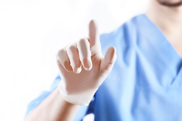 Doctor hand in sterile gloves showing sign isolated on white background