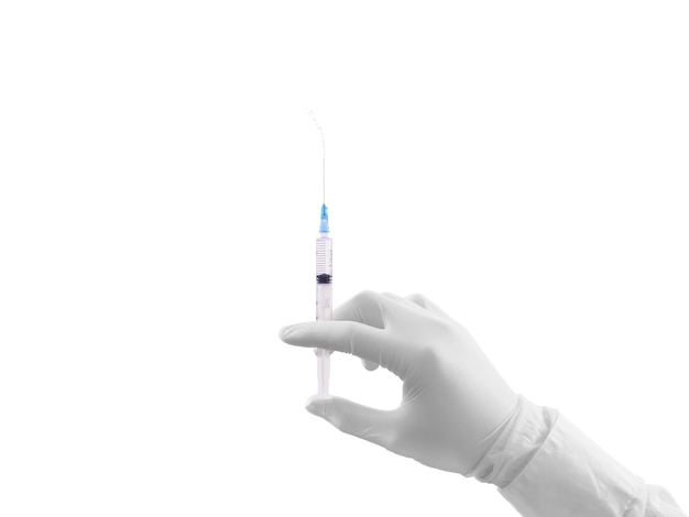 Doctor hand in white glove hold syringe with preparation jet from the needle.