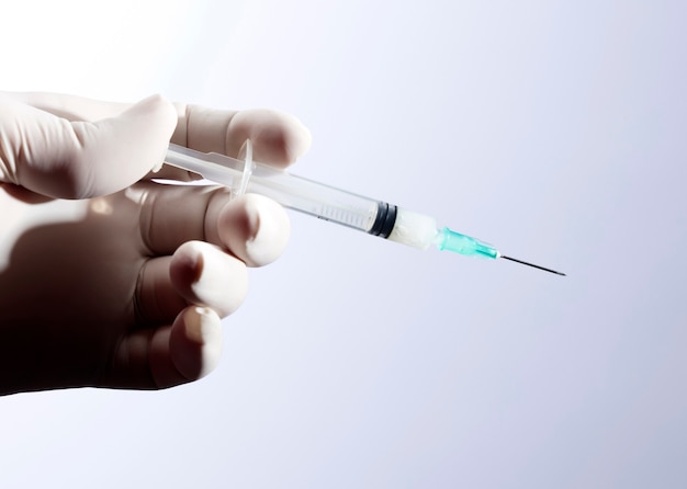 doctor hand with syringe for coronavirus vaccine injection.