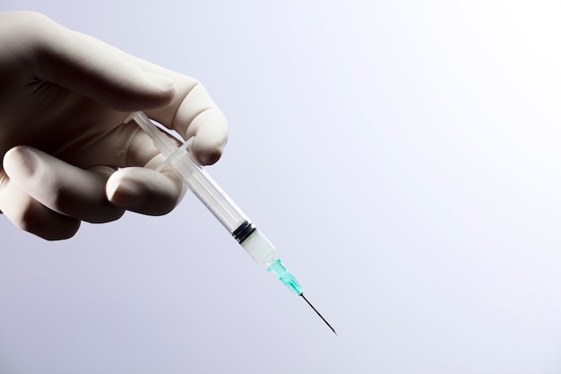 doctor hand with syringe for coronavirus vaccine injection.
