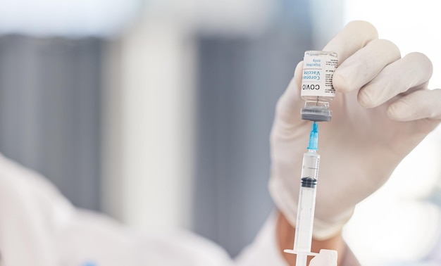 doctor hands and syringe for covid vaccine virus and pharmacy medicine hospital or clinic service medical compliance or healthcare professional or nurse with needle and corona virus glass bottle