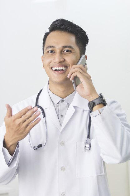 Doctor having phone call at his medical office