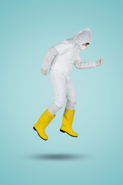 Doctor in hazmat suit running in studio