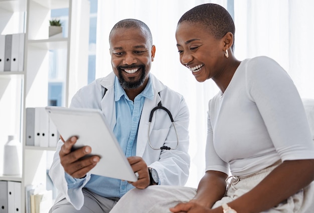 Doctor healthcare and medicine with a patient talking test results and progress on a tablet in a hospital clinic Trust help and medical consulting with a professional medicare worker in his office