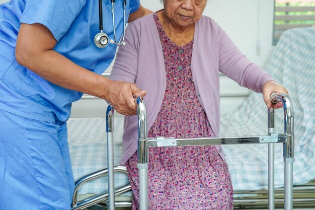 Doctor help Asian elderly woman disability patient in nursing hospital medical concept