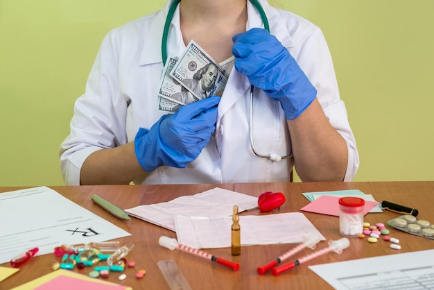 Doctor hide dollar banknotes into robe pocket