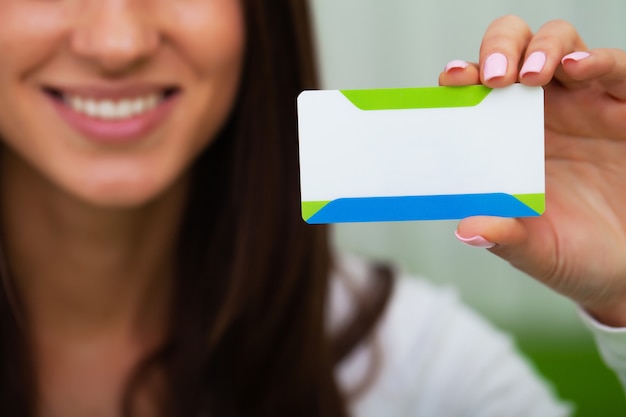 Doctor holding blank business card with place for text