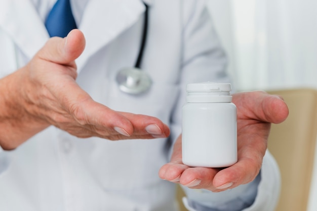 Photo doctor holding bottle of pills