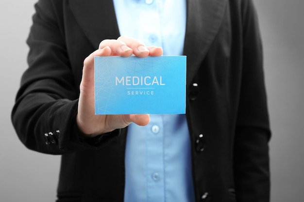 Doctor holding business card closeup