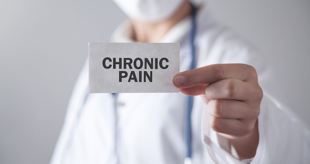 Doctor holding card. Chronic Pain