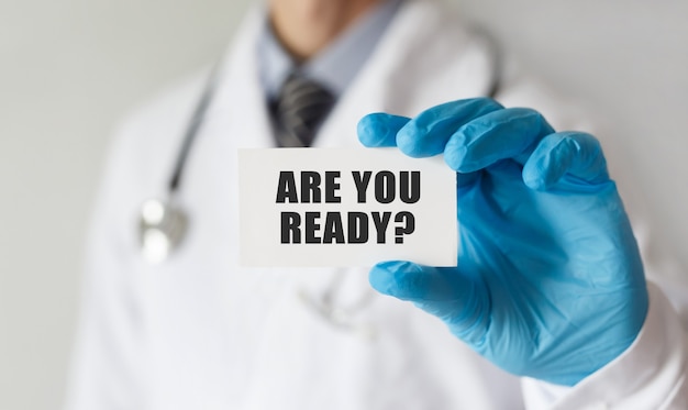 Doctor holding a card with text Are you ready