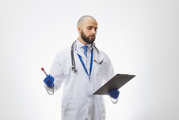 A doctor holding a coronavirus blood test in his hand.