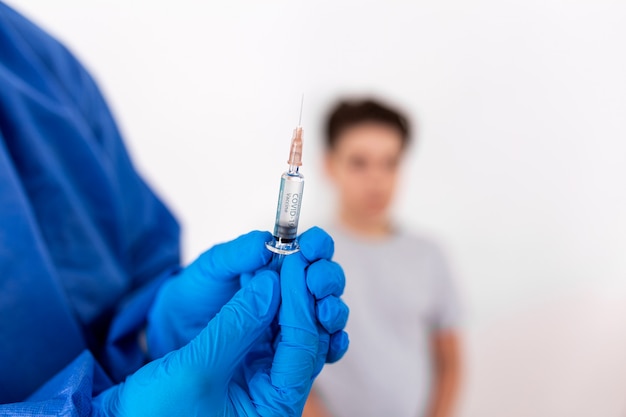 Doctor holding coronavirus vaccine in his hands